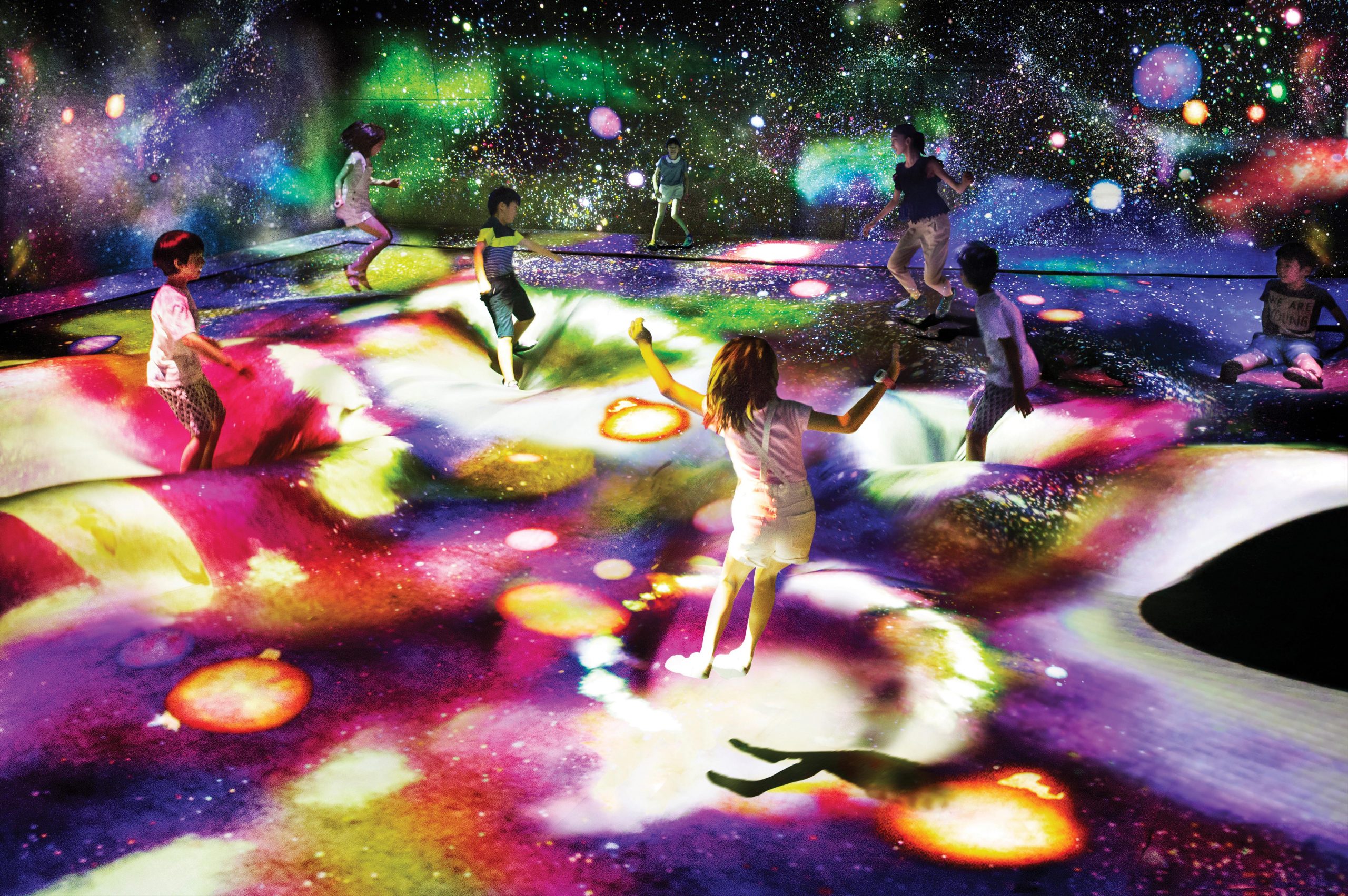 The teamLab exhibition's 'Multi Jumping Universe' section offers visitors an interactive experience under the stars. You can jump' or 'sink' with other visitors as new stars are born when the installation's surface becomes distorted - Photo by teamLab