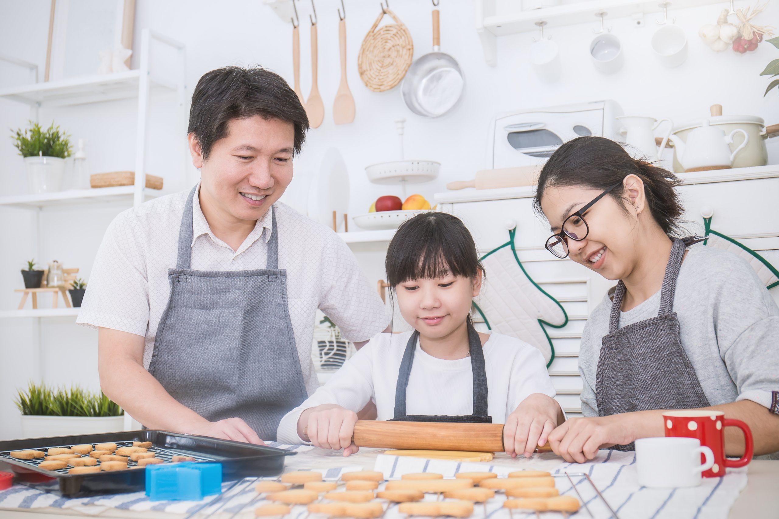 Portrait Of Little Asian Girl And Her Parents Baking Cooking