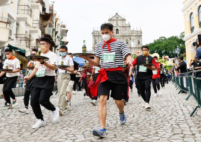 Runners compete in traditional Tray Race for World Tourism Day