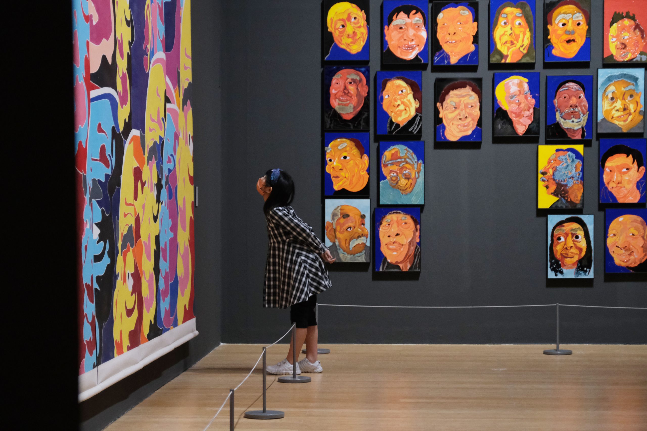 A young visitor admires Fang Lijun's work at the Macao Museum of Art