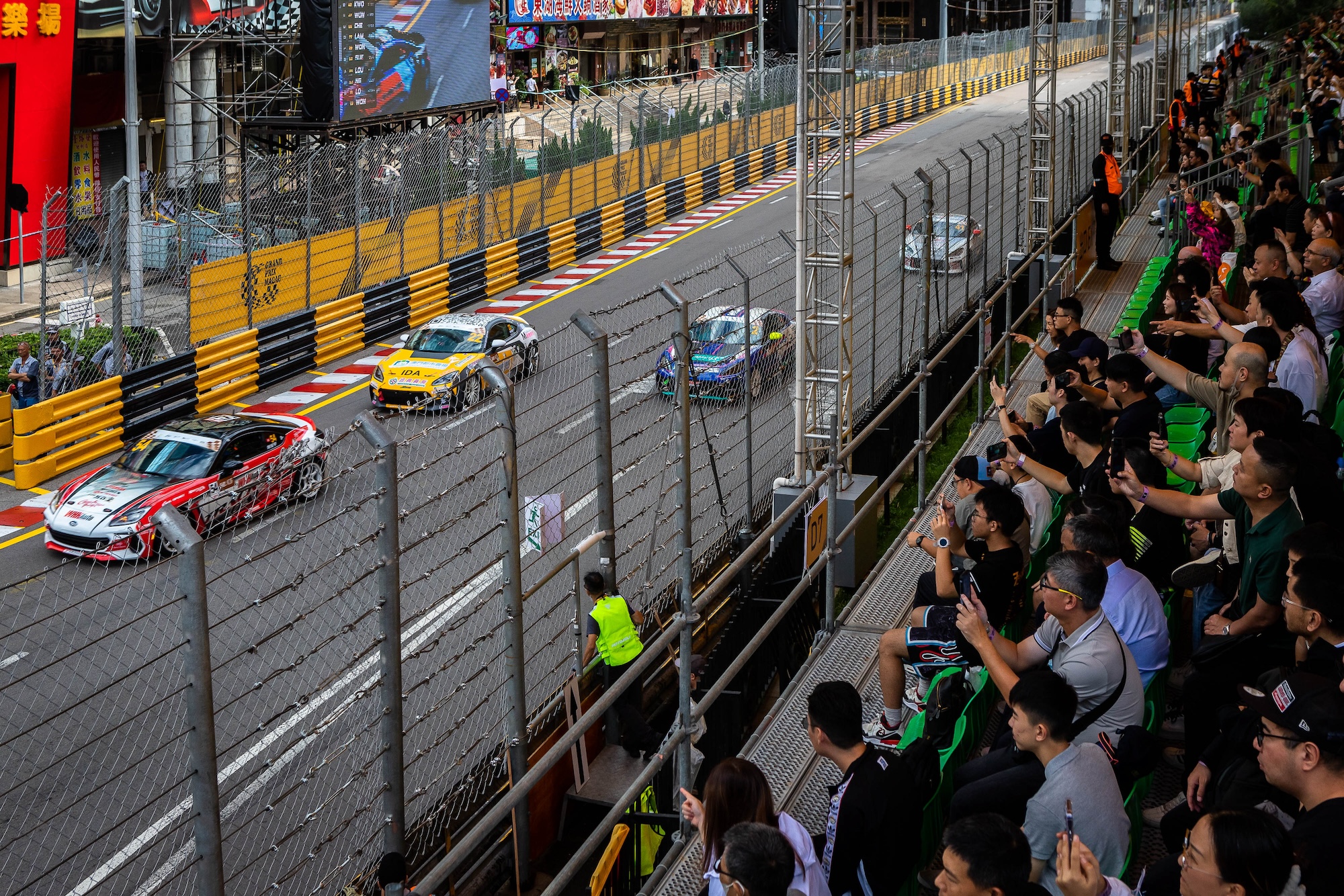 Members of the public follow the Macau Roadsports Challenge race from the spectator stands
