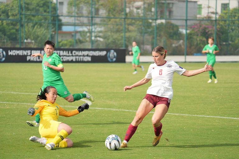 Macao women's football team's Oriana Wong battling it out with Guam's Rebecca Bartosh in the second preliminary match of the East Asian Football Federation’s Women’s Football Championship