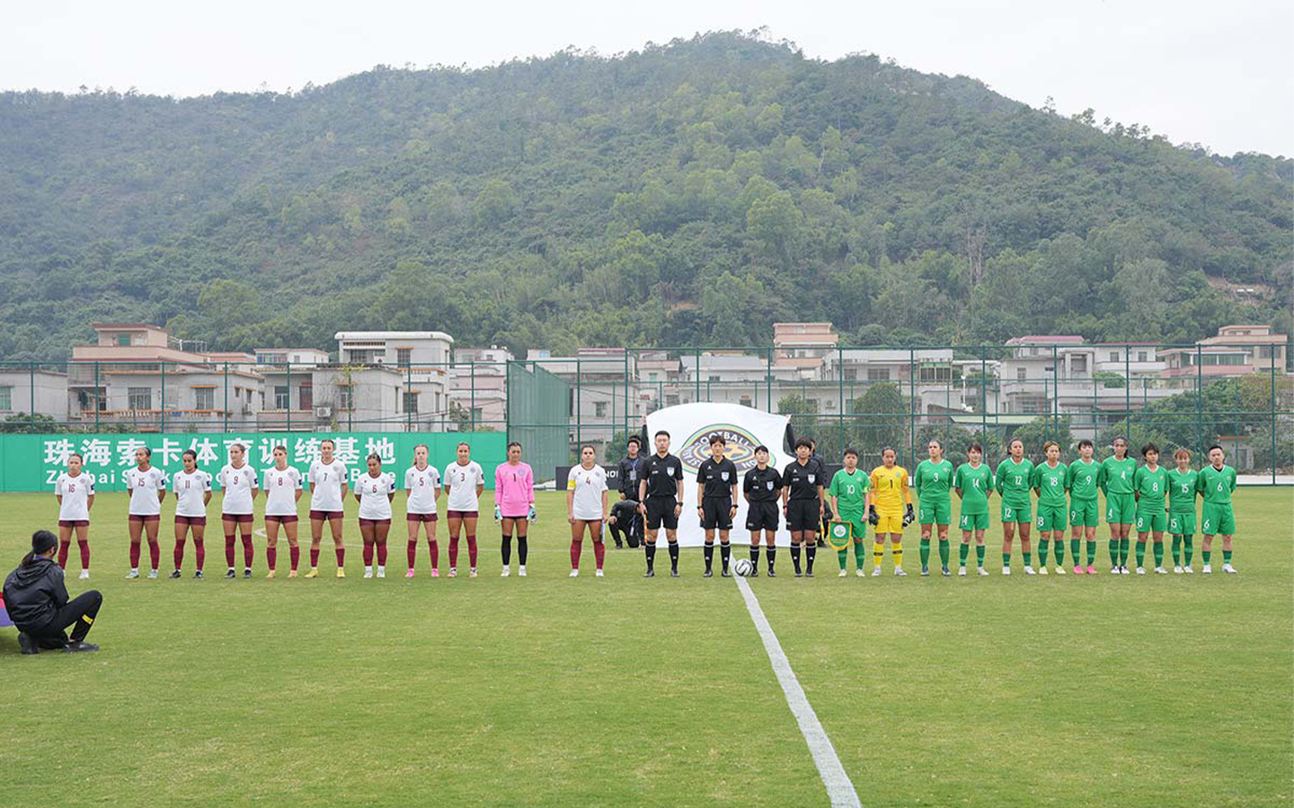 The Macao and Guam women's football team lined up before the match