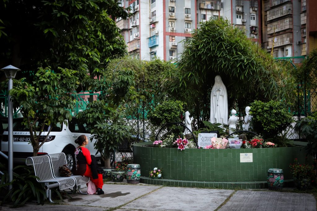 A Vietnamese Catholic contemplates a shrine at Our Lady of Fátima Church in Macao, November 2023