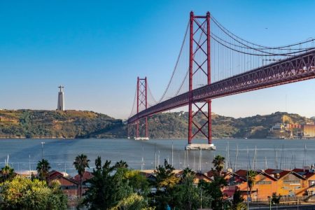 Macau to Portugal direct flights - 25 de Abril Bridge arching over the Tagus River in Lisbon, Portugal