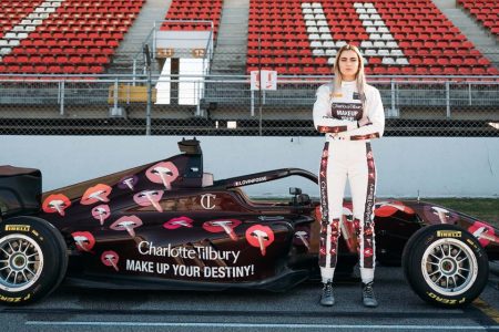 French driver Lola Lovinfosse stands with her vehicle in the new Charlotte Tilbury livery in this undated handout photo