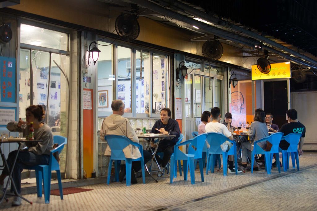 The restaurant's outdoor tables are a popular gathering place for the Macanese community