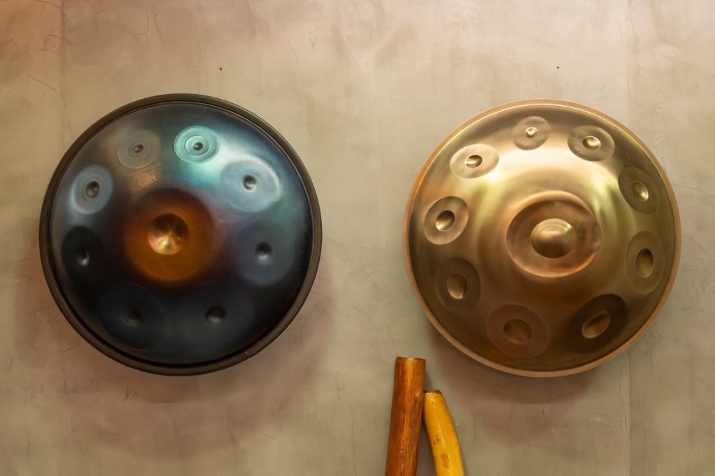 A nitrided steel handpan (left) and stainless steel handpan (right)