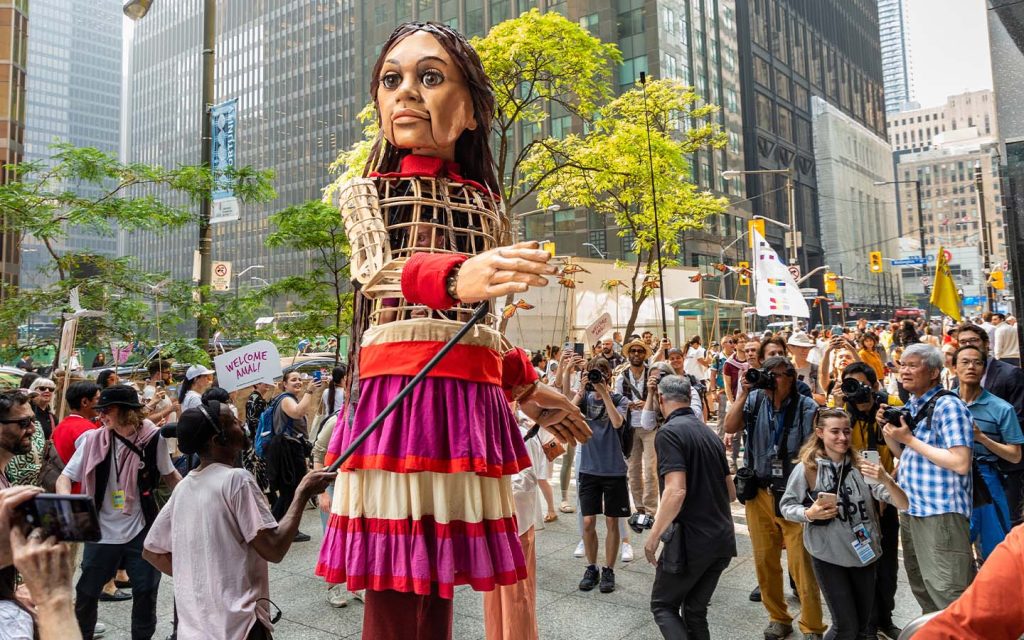 Little Amal, a 3.5-metre puppet representing a 10-year-old Syrian refugee, is seen in Toronto in June 2023. It’s creators have now embarked on a project to raise awareness of climate change