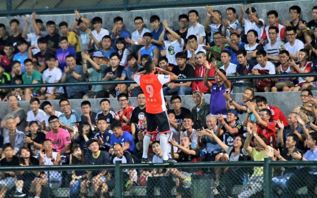 Gomes celebrating with fans after scoring the winner for Ka I against Benfica Macau in 2015