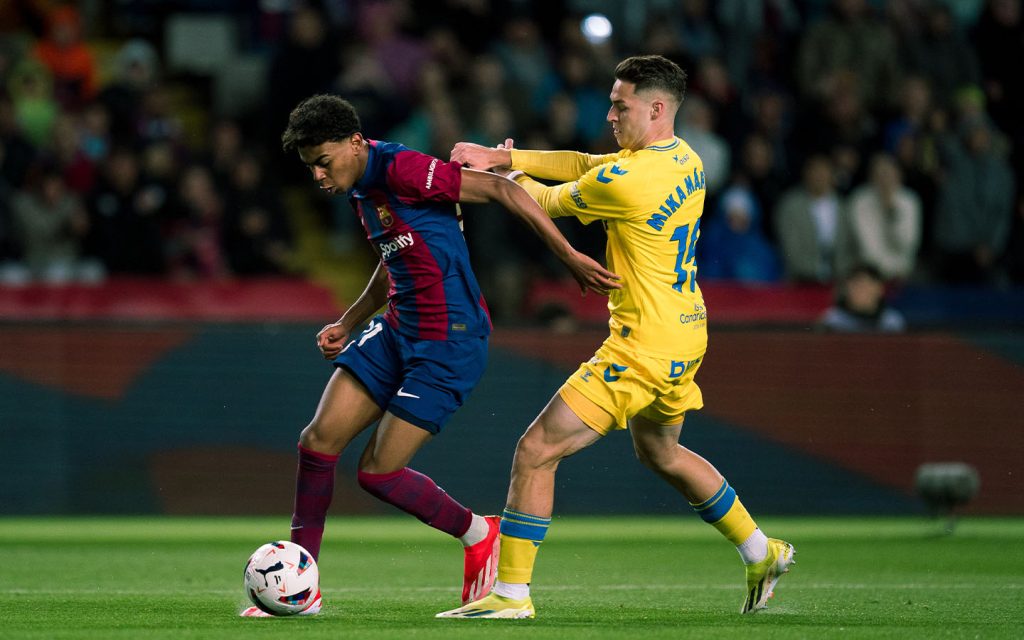 Barcelona’s Lamine Yamal defending against Mika Marmol of Las Palmas during a La Liga match on 30 March 2024