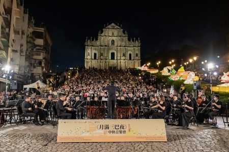 Orchestra playing against the Ruins of St Pauls.