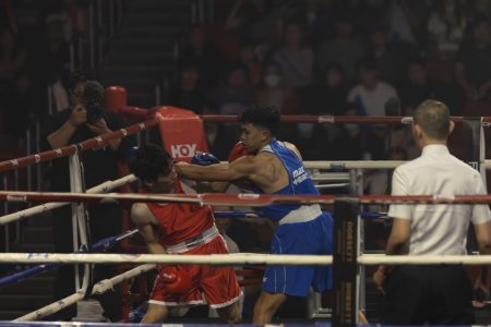 Alvin Salinas (in blue) throws a punch while representing Macao at last year’s Ultimate Extreme Fight event