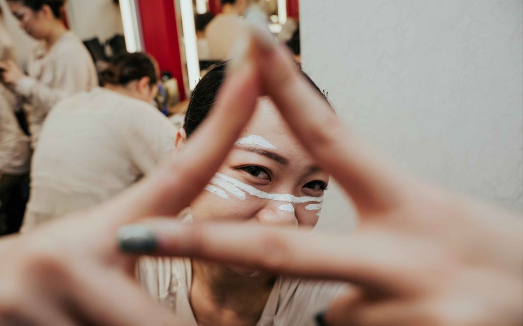 Rebel Z crew member Lam Cheng Cheng flashes the group’s signature hand sign