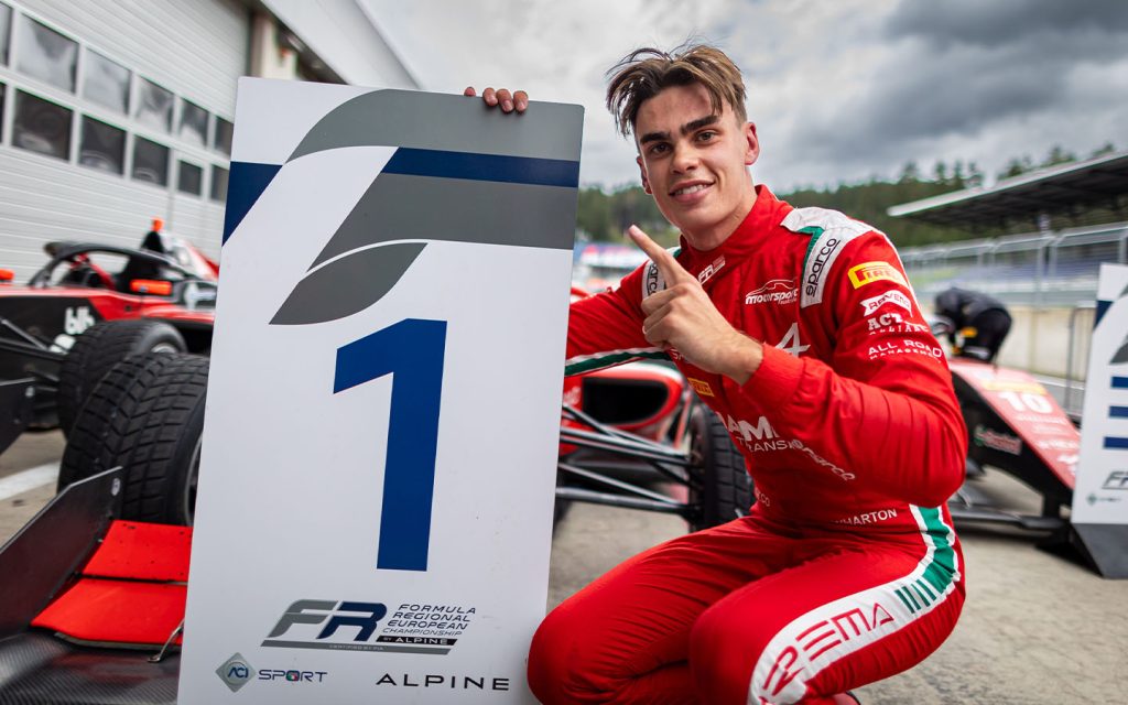 James Wharton pictured alongside is first place sign board at the Red Bull Ring on 14 September 2024