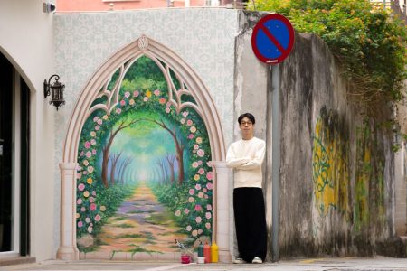 Local artist Vitorino Vong pictured along his most recent work for Vertelli Macau, a centre offering aromatherapy