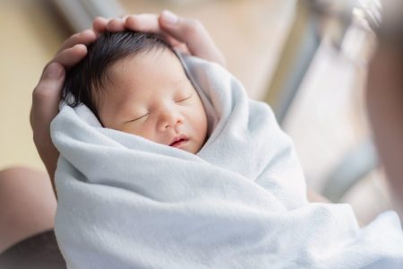 Baby being held in father's arms