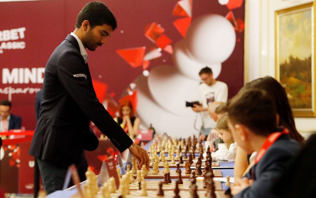 World Champion chess grandmaster Gukesh Dommaraju makes a move during a demonstrative simultaneous chess game with Romanian children and teenager players at the official opening ceremony of the Grand Chess Tour 2025 tournament in Romania in May 2025