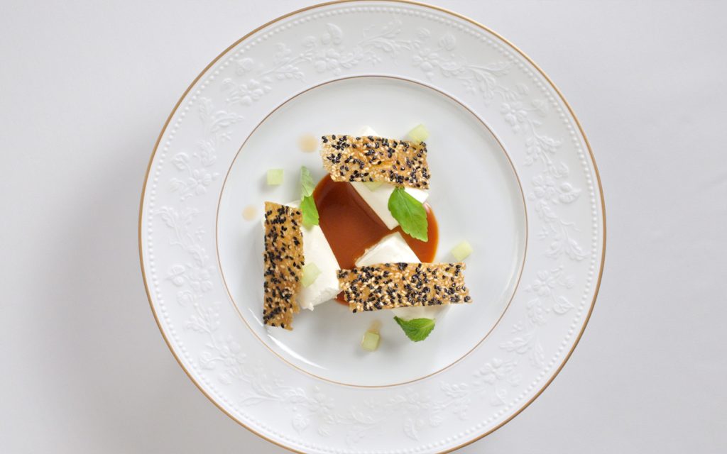 Cylinders of rice cake mousse masquerade as tteokbokki, complete with smoky-sweet gochujang caramel and bright melon cubes for a surprising dessert twist