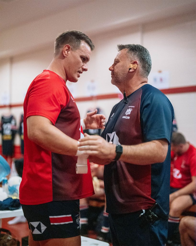 Tommy Hill shares a moment with coach Andrew Douglas in the locker room