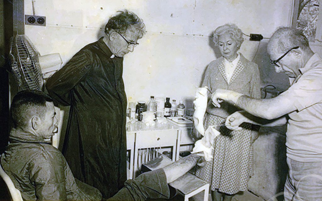 Nicosia watches a patient’s bandages get changed in 1970