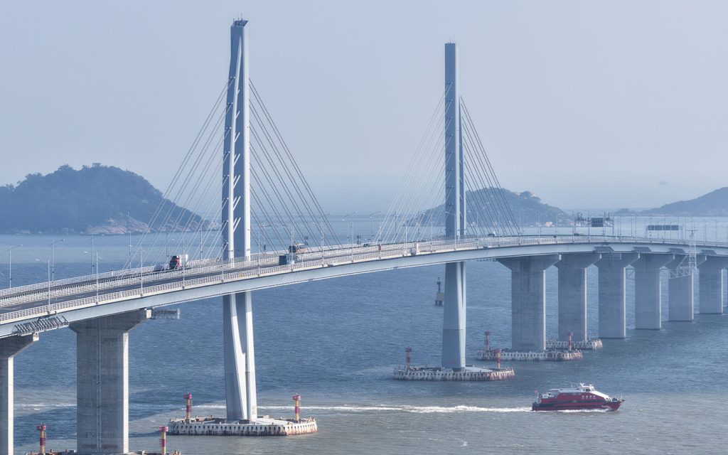 An aerial drone photo taken on 19 October 2025 shows cruise ships passing under the Hong Kong-Zhuhai-Macao Bridge in south China
