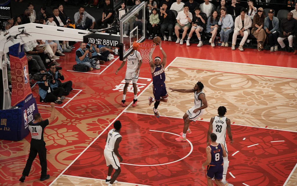 NBA action returns to Macao as the Phoenix Suns attack the basket against the Brooklyn Nets in preseason play