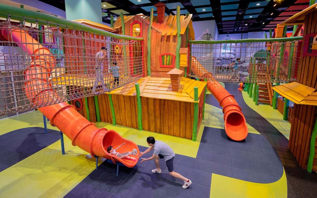 Kids move between themed indoor play zones spread across multiple levels