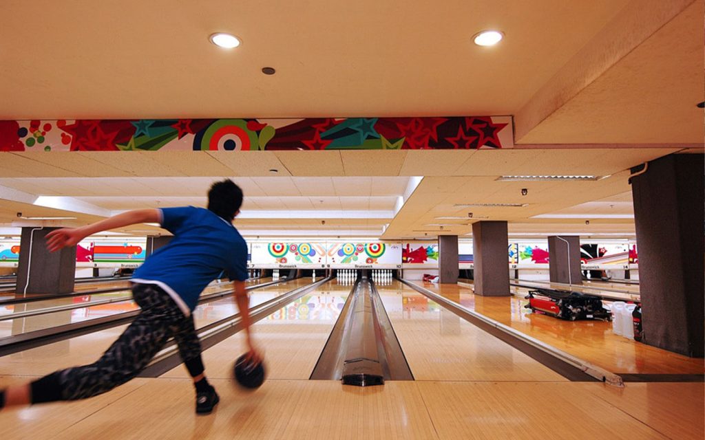 Groups gather for casual games at a full-sized indoor bowling centre in Cotai