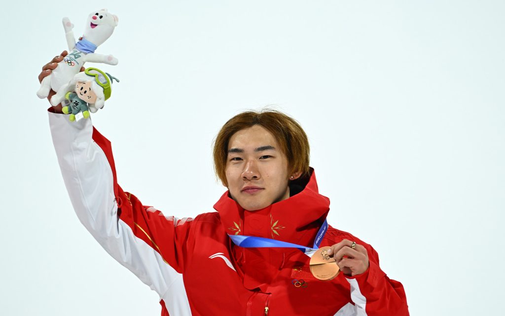 Bronze medalist Su Yiming gestures during the awarding ceremony at the Milan-Cortina 2026 Olympic Winter Games