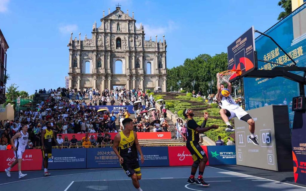 A player dunks during a 3×3 basketball game in front of the Ruins of St Paul’s in Macao, a landmark venue for the Greater Bay Area Tour finals